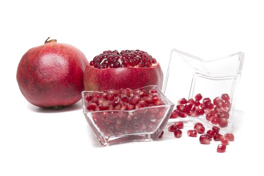 Close up view of tasty pommegranate fruit isolated on a white background.