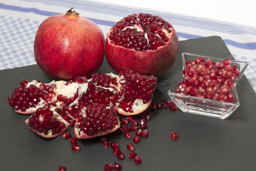 Close up view of tasty pommegranate fruit on top of a slate stone.