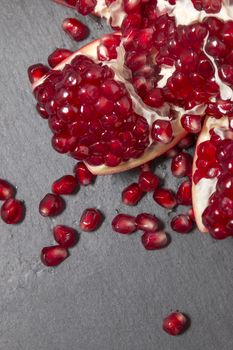 Close up view of tasty pommegranate fruit on top of a slate stone.