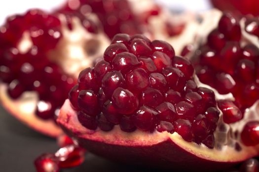 Close up view of tasty pommegranate fruit on top of a slate stone.