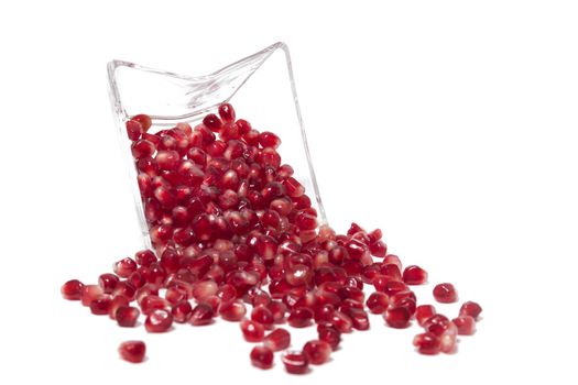 Close up view of tasty pommegranate fruit seeds isolated on a white background.