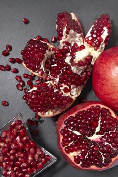 Close up view of tasty pommegranate fruit on top of a slate stone.