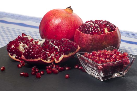 Close up view of tasty pommegranate fruit on top of a slate stone.