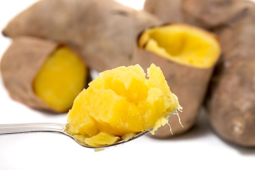 Cooked oven sweet potatoes isolated on a white background.