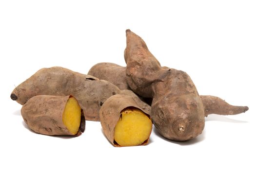 Cooked oven sweet potatoes isolated on a white background.