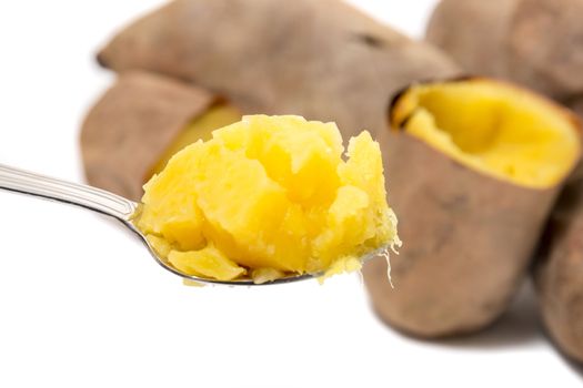 Cooked oven sweet potatoes isolated on a white background.