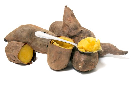 Cooked oven sweet potatoes isolated on a white background.