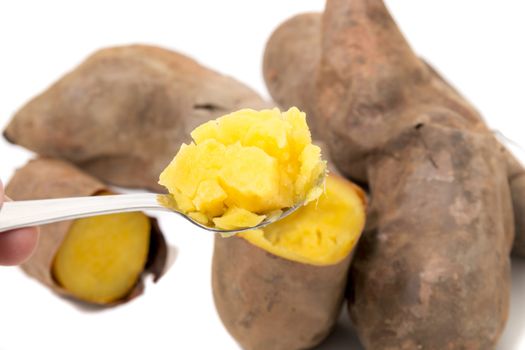 Cooked oven sweet potatoes isolated on a white background.