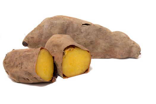 Cooked oven sweet potatoes isolated on a white background.