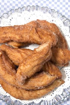 Portuguese Farturas or Spanish Churros, Fried dough sticks on a table cloth.