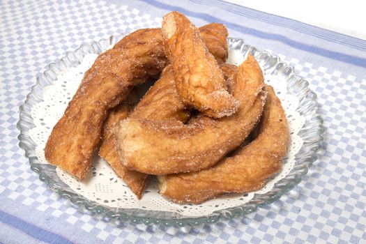 Portuguese Farturas or Spanish Churros, Fried dough sticks on a table cloth.