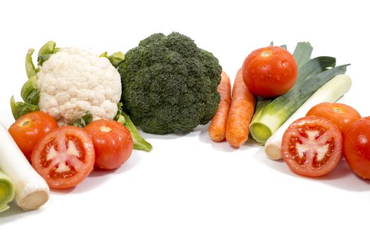 Mixed wet vegetables isolated on a white background.