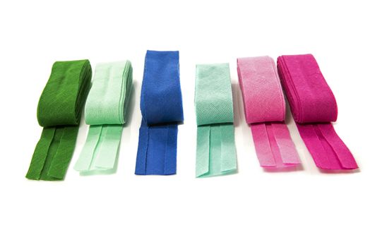 bias binding in blue green and purple isolated on white with text space