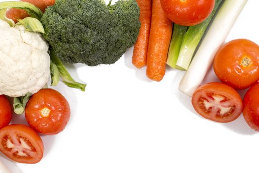 Mixed wet vegetables isolated on a white background.