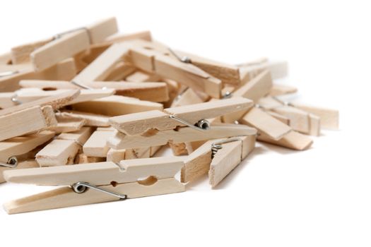 Pile of clothing pegs isolated on a white background.