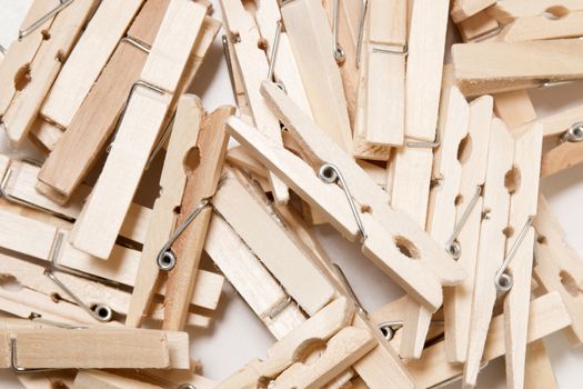 Pile of clothing pegs isolated on a white background.