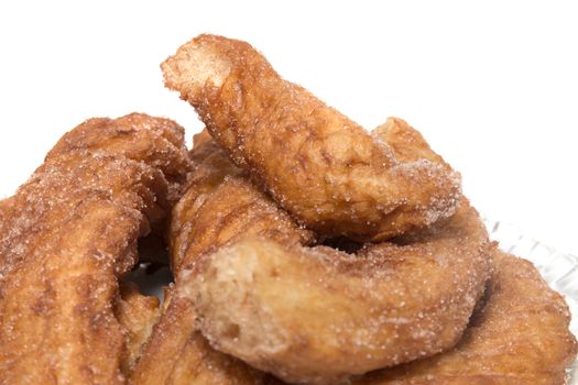 Portuguese Farturas or Spanish Churros, Fried dough sticks isolated on a white background.