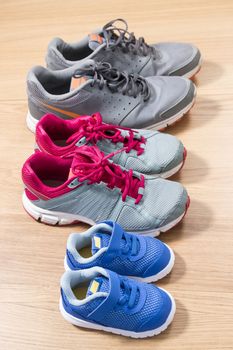 Three pairs of sneakers for the whole family, dad, mom and child.
