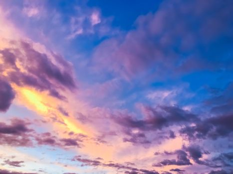 Sunset sky and clouds background. Beautiful purple shades.