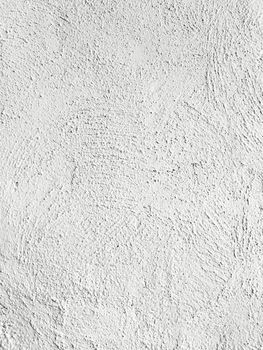 Gray textured concrete wall with traces of paintbrush.