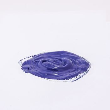 a drop of acrylic blue color on a white surface