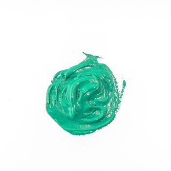 a drop of acrylic green color on a white surface