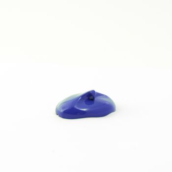 a drop of acrylic blue color on a white surface