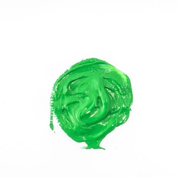 a drop of acrylic green color on a white surface