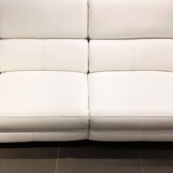 Empty luxurious white leather sofa. Classy furniture.
