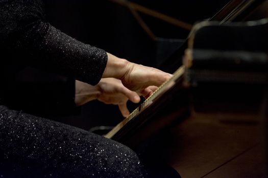 woman plays piano in a concert