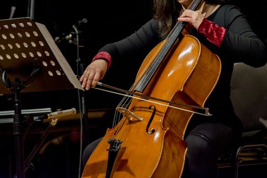 young woman plays cello