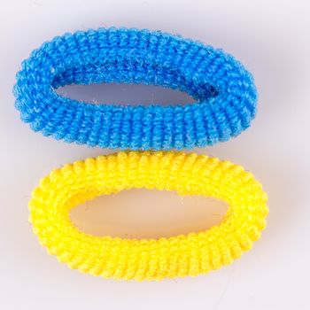 Yellow and blue soft hair bands on a white background