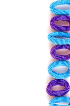 Blue and purple soft hair bands are lined with a line on a white background