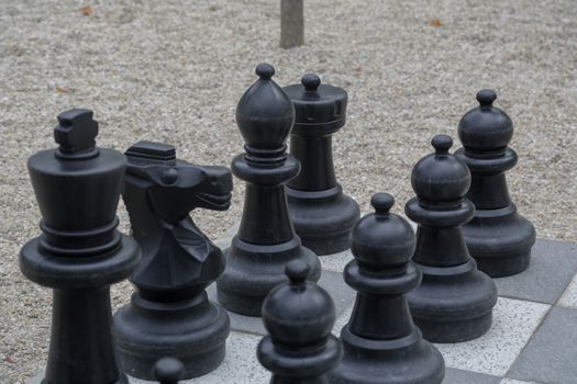 Black and white king on a chess board in open air