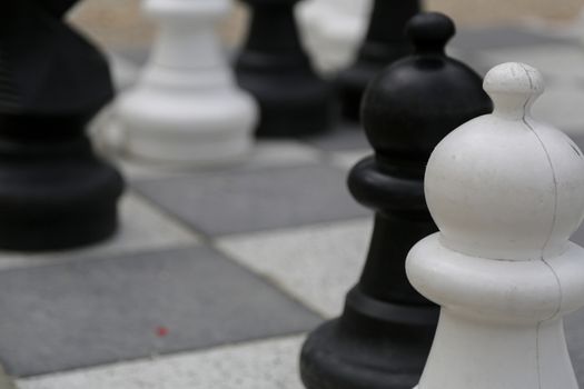 Black and white king on a chess board in open air