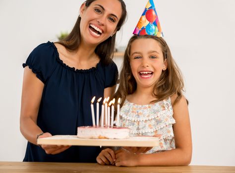 Shot of a mother and daughter in the kitchen celebrating Daughter's birthday