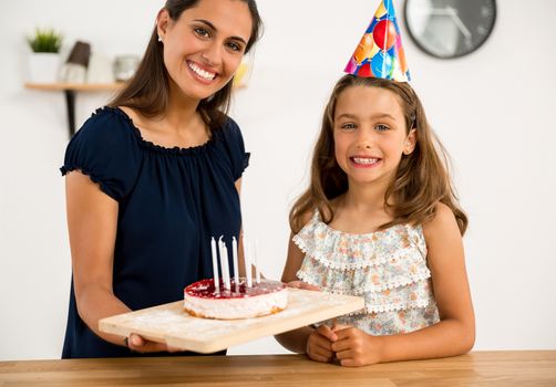 Shot of a mother and daughter in the kitchen celebrating Daughter's birthday