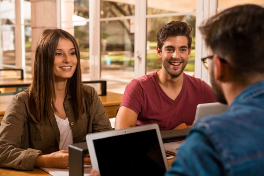 Groups of friends studying together on the bibliotech