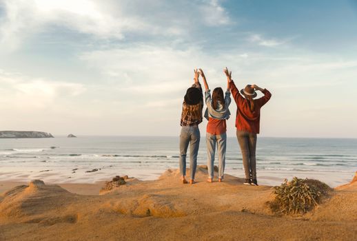 Best friends near the coastline looking to the sea