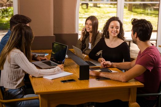 Groups of friends studying together on the bibliotech