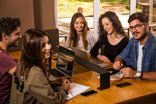 Groups of friends studying together on the bibliotech