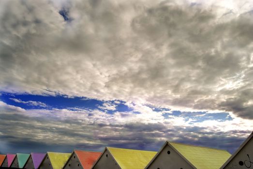 colored wooden roofs of sea cabins against colored roofs of sea cabins