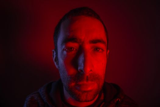 Man with serious facial expression. Close up portrait of expressionless young man.