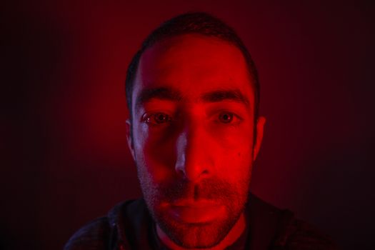 Man with serious facial expression. Close up portrait of expressionless young man.