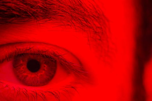 Macro on man eye expressing serious and expressionless expression.