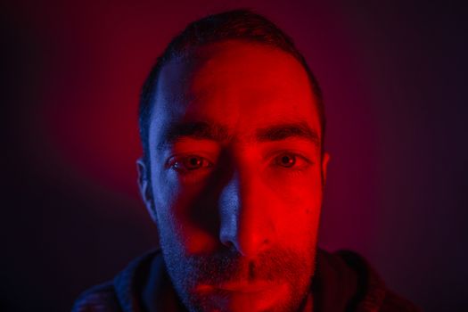 Man with serious facial expression. Close up portrait of expressionless young man.