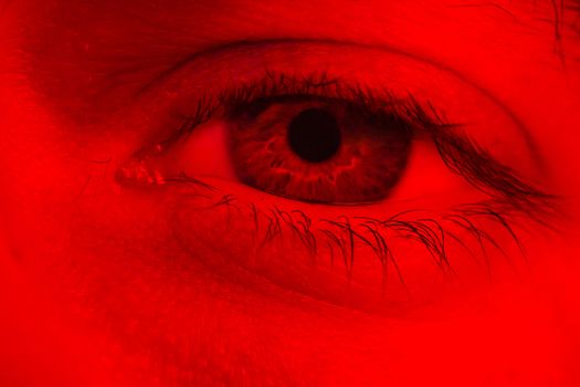 Macro on man eye expressing serious and expressionless expression.