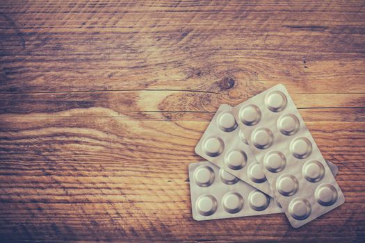 Medical Image Of A Blister Pack Of Prescription Medication On A Rustic Wooden Table