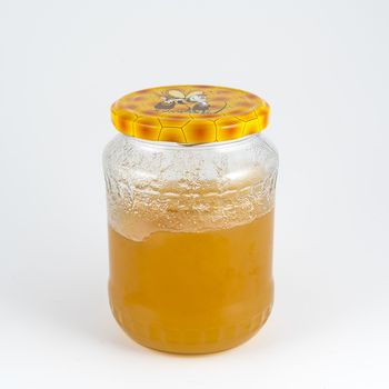 a glass jar containing honey