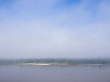 Sand bar of the Mekong River in the mist.